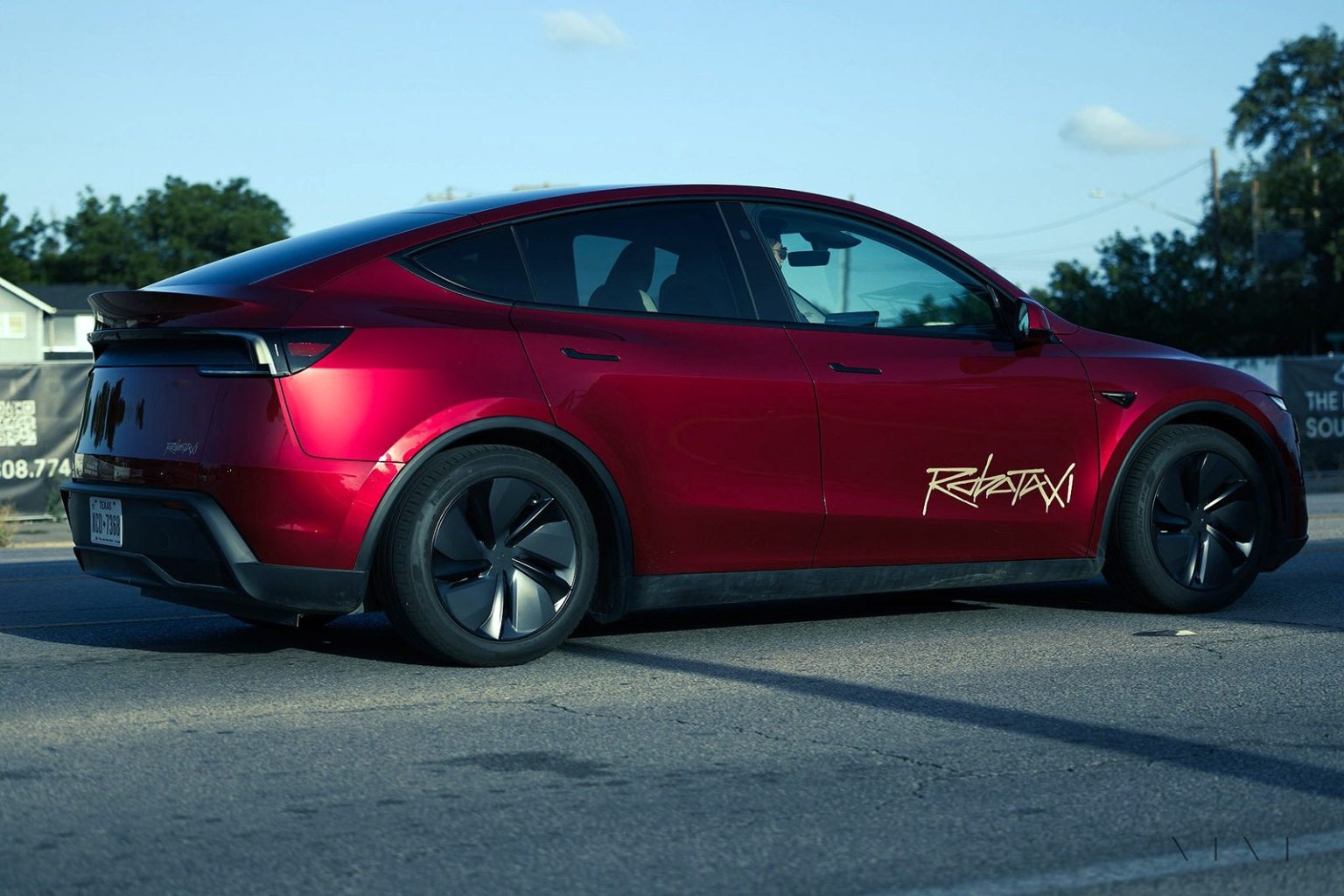 A Tesla Model Y robotaxi painted in Ultra Red.
