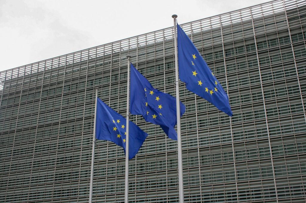 EU 2035 CO2 Proposal Could Leave Room For Combustion Cars, T&E Warns three european flags flying in front of a building