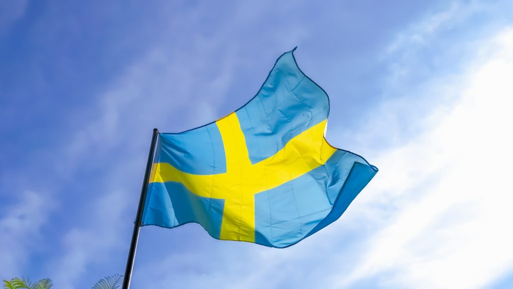 a blue and yellow flag flying in the sky