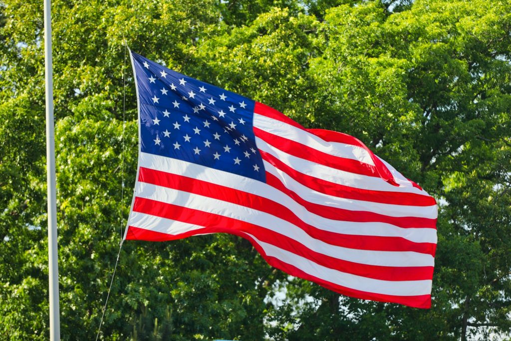 U.S. Lawmakers Propose Federal Safety Standard for EV Door Releases us a flag on flag pole