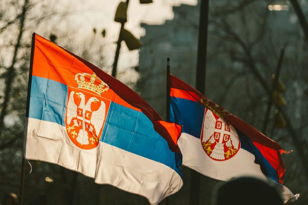 Serbia Restarts EV Subsidy Scheme with €1.5 Million Budget for 2025 two flags with a coat of arms on them
