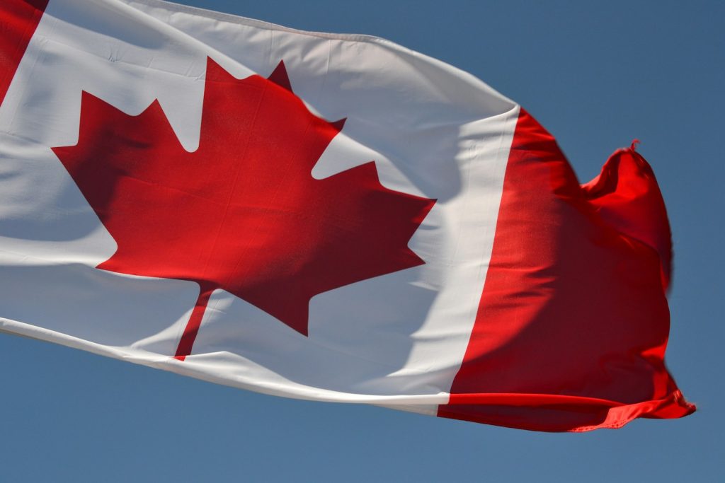 Canada Explores Sino-Canadian EV Assembly Plant to Boost Global Exports red and white flag under blue sky during daytime