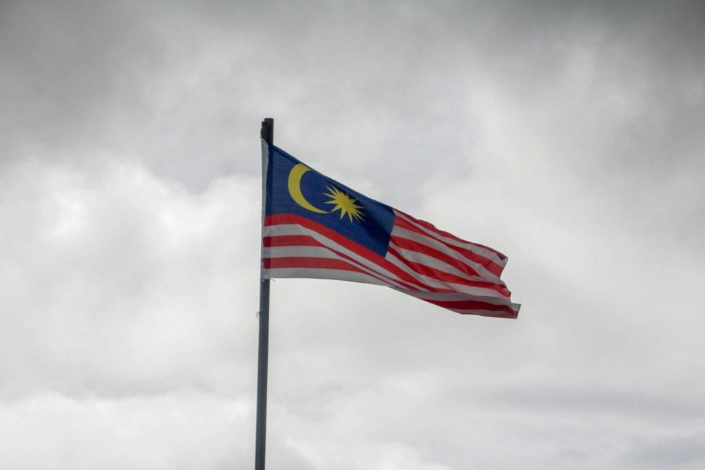 Malaysia Tightens EV Import Rules to Promote Localisation red blue and white flag under white clouds