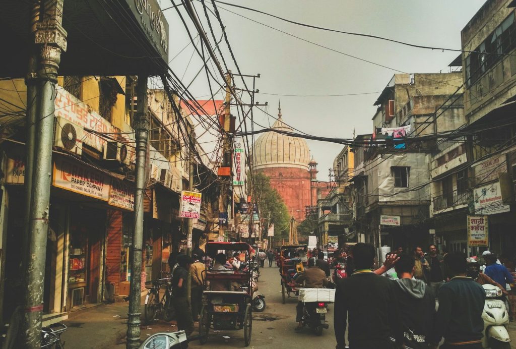 group of people on concrete road between buildings