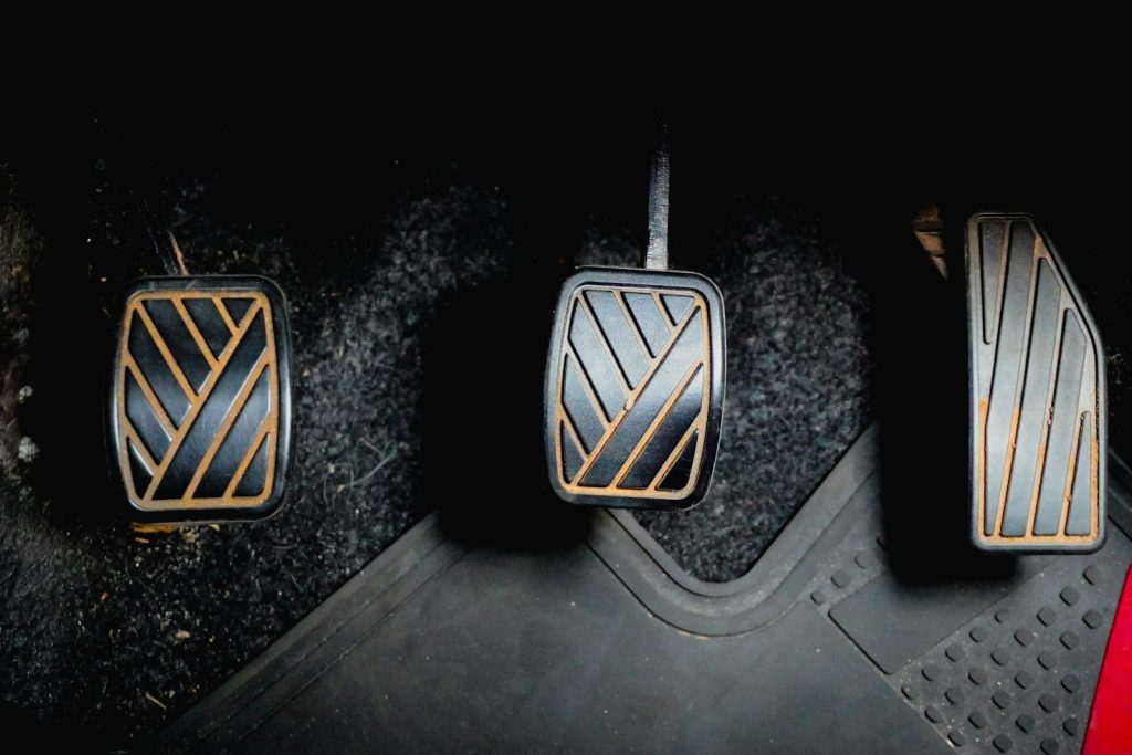 Three car pedals on the floor
