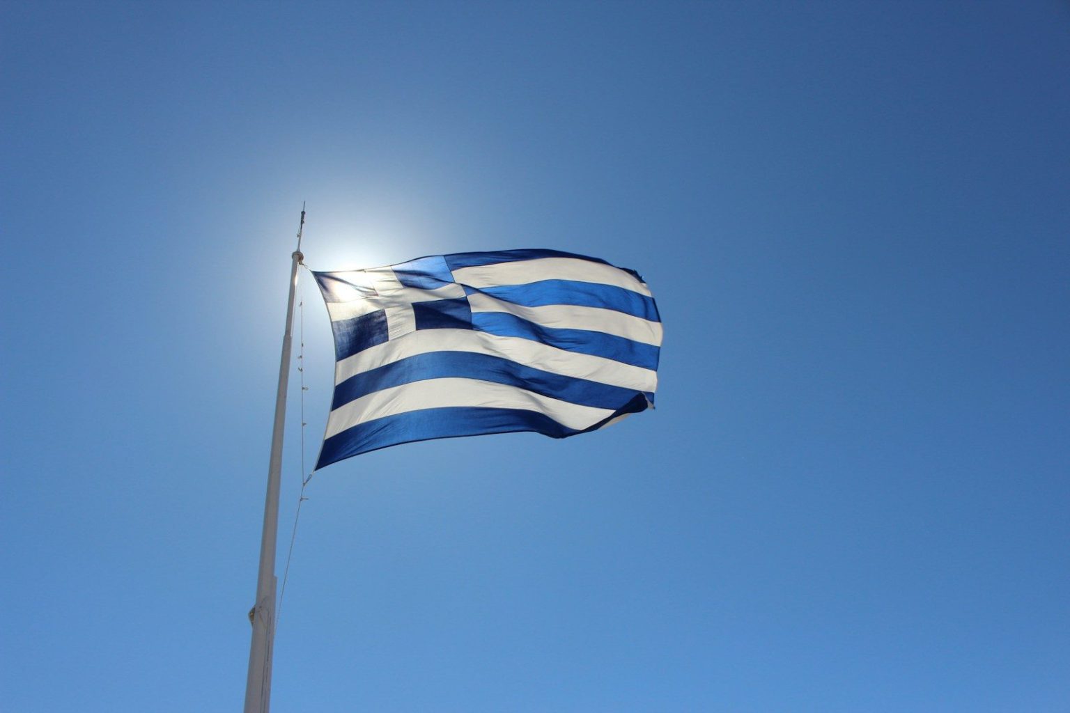 Greece Tightens E-Scooter Rules With Helmet, Insurance and Age Requirements blue and white flag