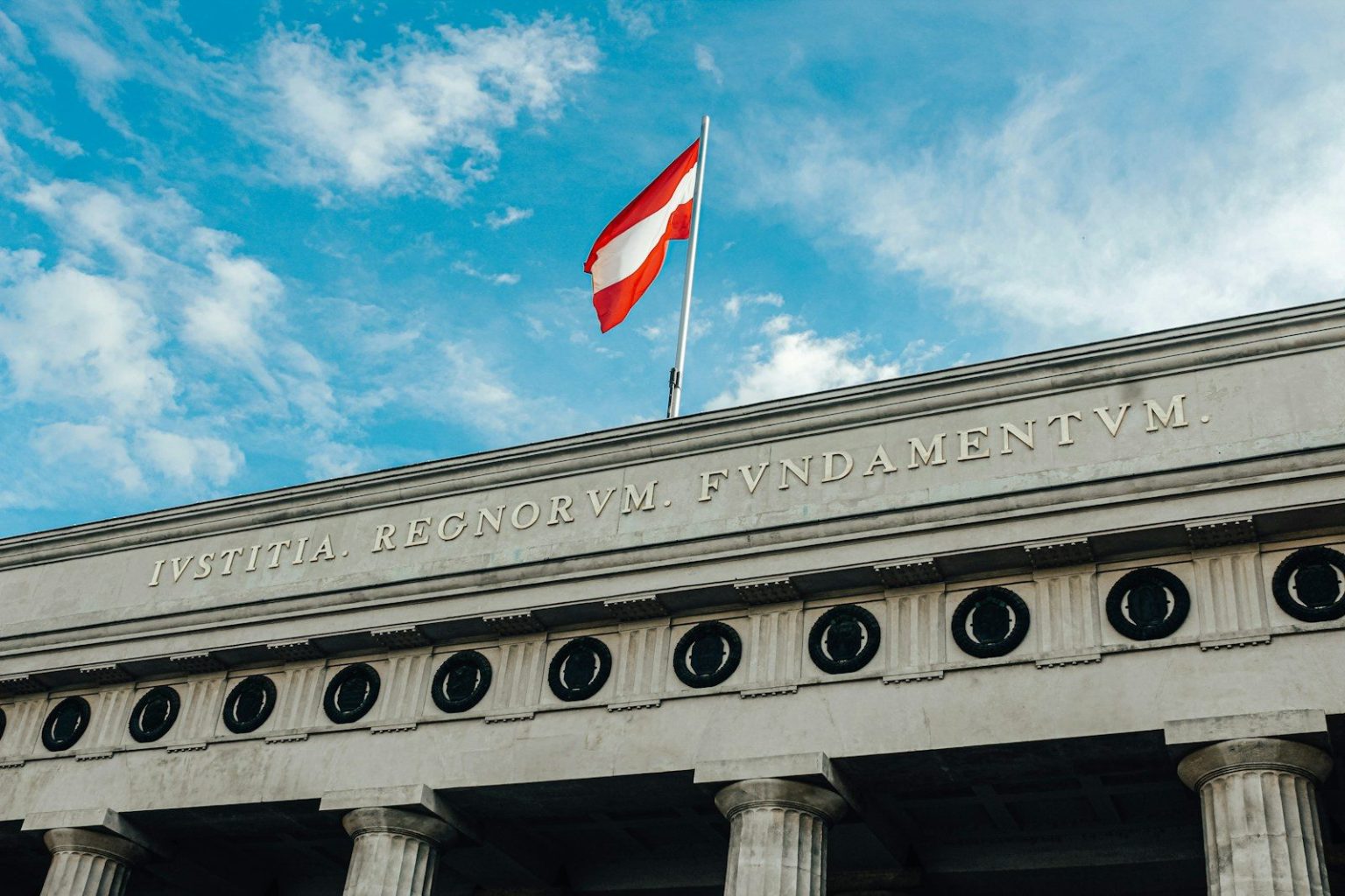 Austria’s Electric Vehicle Registrations Rise 27% in First Half of 2026 a flag is flying on top of a building