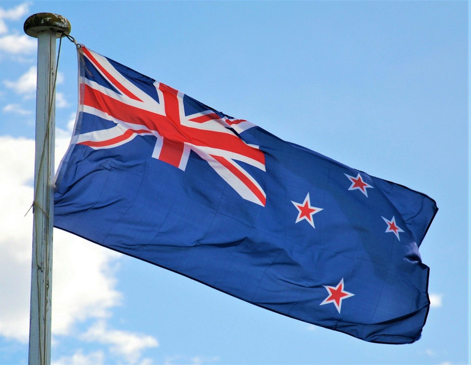 Australia Commits AU$40.5 Million to Expand Australia Post’s Electric Vehicle Fleet a flag on a pole